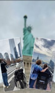 Blurred Statue of Liberty in the background. Two small photos superimposed on the blurred photo. The photo on the left is of a man with curly blonde hair wearing a black leather jacket and blue jeans taking a photo of the World Trade Center building in the near distance. To his right is a woman sitting in a wheelchair looking at the World Trade Center building. She is wearing a black leather jacket and a white knit hat with a pom-pom on top. The photo on the right is of a woman with curly brown hair, wearing a blouse with vertical stripes of various shades of blue and blue jeans. Her right arm is around a man with brown hair and a navy blue jacket, seated in a wheelchair. They are looking at the skyline of the southern part of Manhattan from the Top of the Rock observation deck.